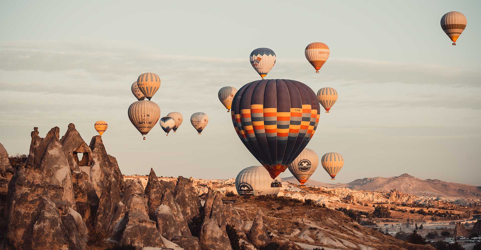 Coloful Hot air balloons in the air and fairy chimneys in the background.