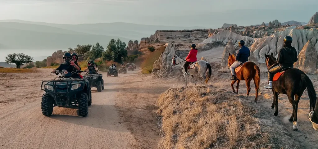 Cappadocia ATV tour and horse riding side by side — quad bikes on a valley trail and horseback riders among fairy chimneys at sunset