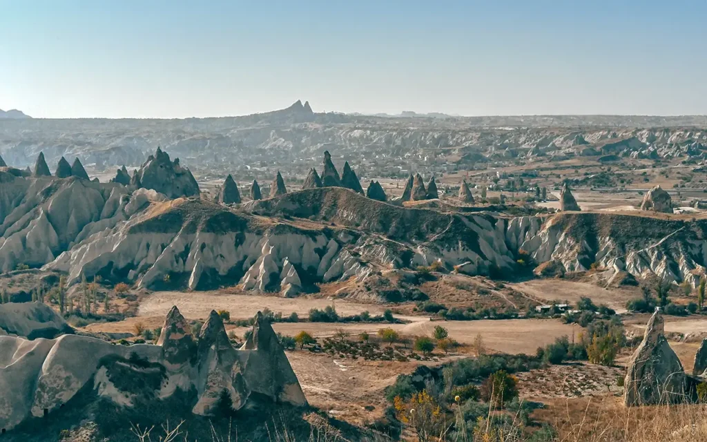 Valley: Pointed fairy chimneys and rugged volcanic terrain of Meskendir Valley.