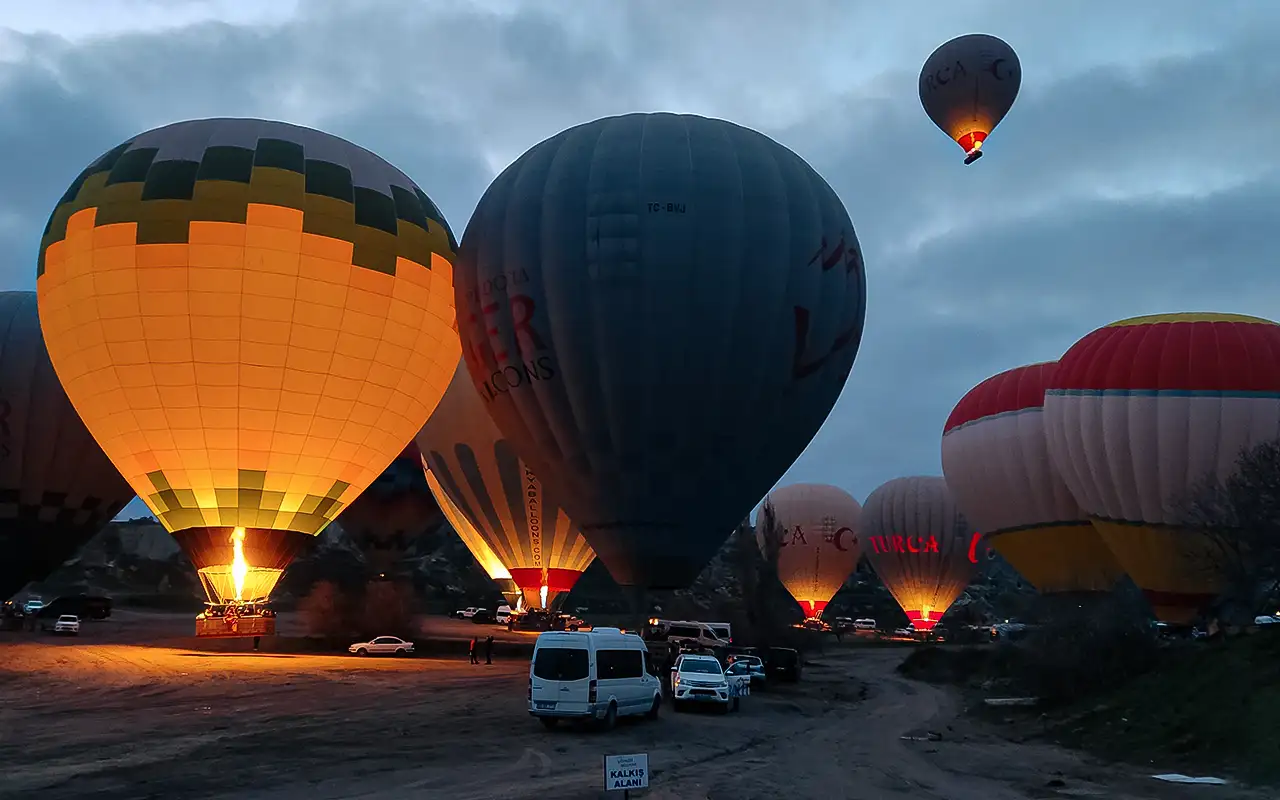 Cappadocia balloon launch field with official KALKIŞ ALANI sign and TC-BVJ registered balloon at the SHGM-designated launch site